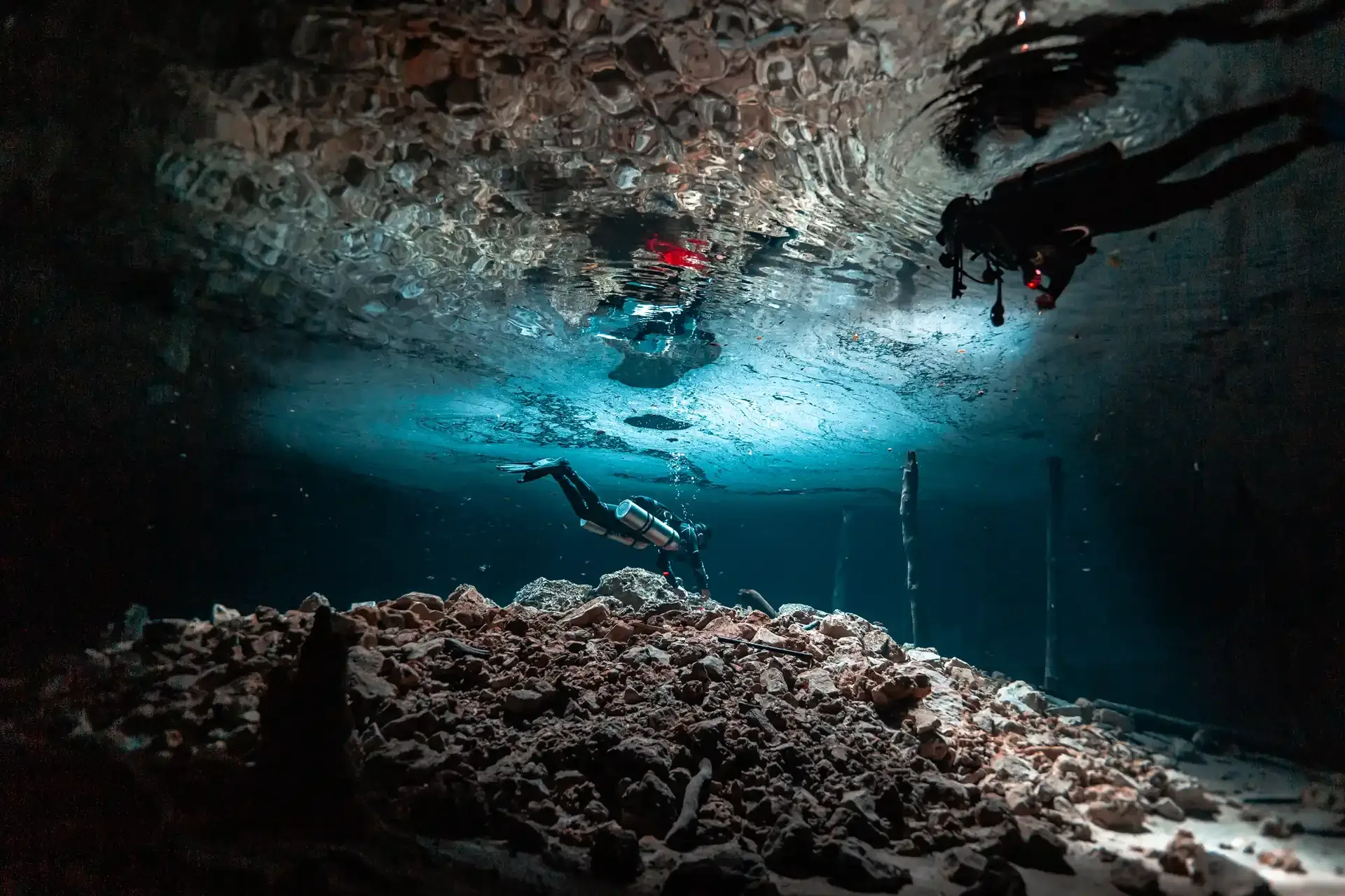 Two divers at the surface inside the Bat Cave at Dos Ojos