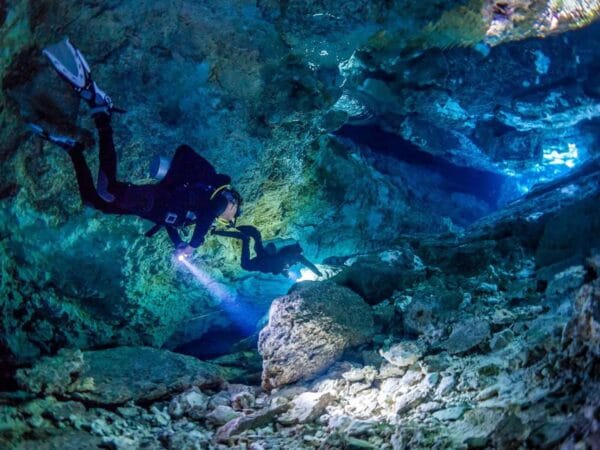Chikin Ha cenote diving with TDI/SDI guides in crystal-clear water and halocline<br>