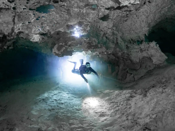 Diver exploring illuminated caverns on the nicte ha cenote diving tour, Dos Ojos & Nicte Ha, Riviera Maya