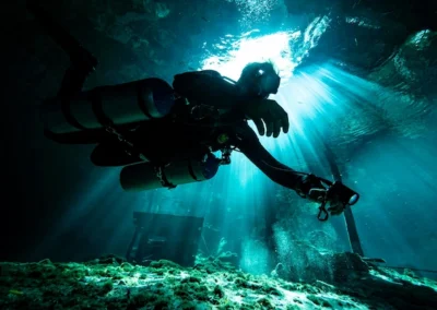 Dreamgate cenote diving with natural light, rock formations, and a technical diver in the Riviera Maya<br> <br> <br>